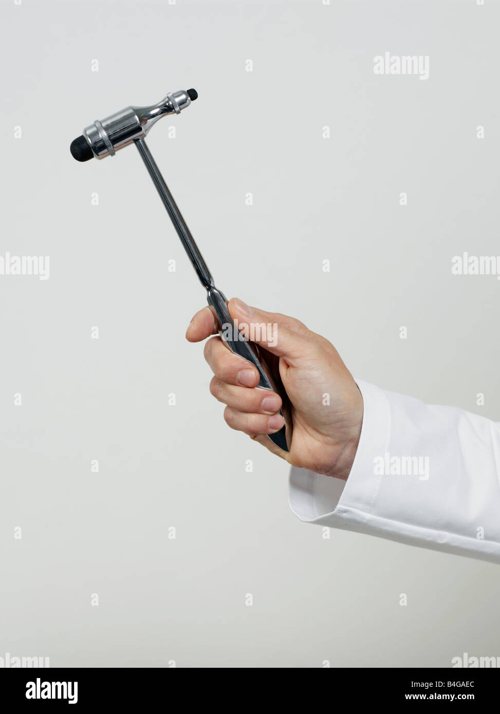 Human hand holding a reflex hammer Stock Photo Alamy