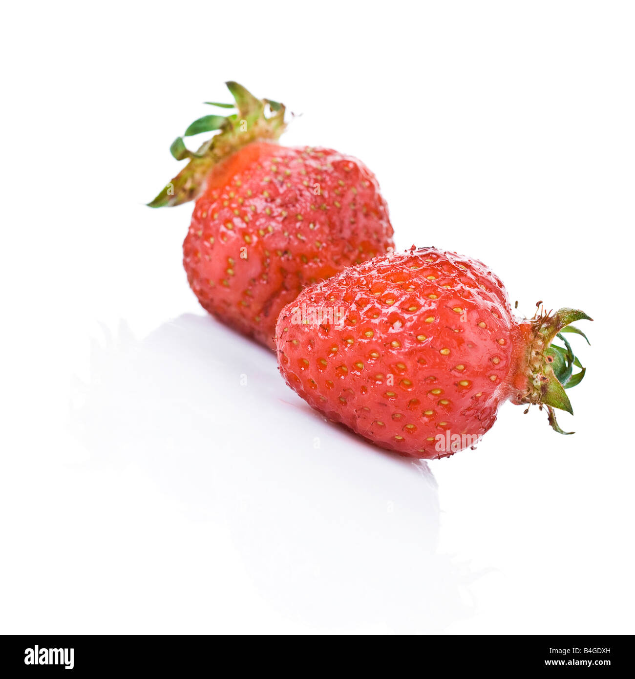 Two strawberries on white background Stock Photo - Alamy