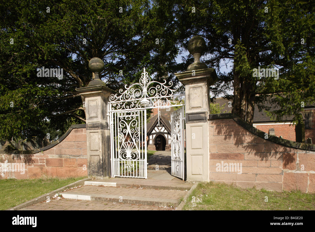 Half open gate to St Mary s Church in Whitegate Cheshire UK Stock Photo