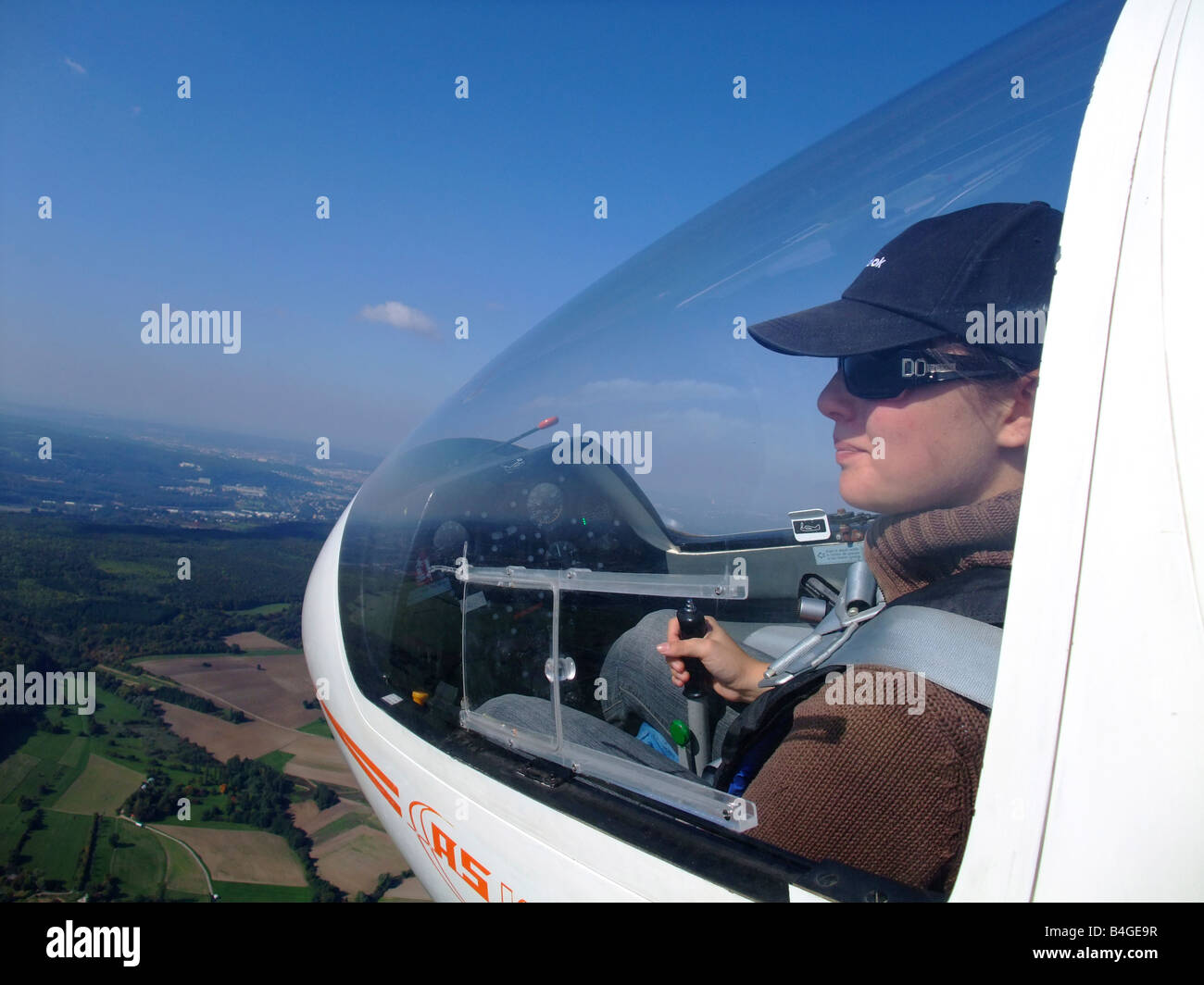 A young woman glider pilot outside view during the flight Glider