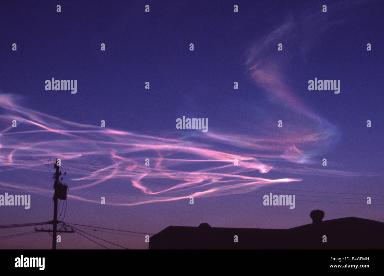 Pink trails fill sunset sky as rocket launches into space above California, USA Stock Photo