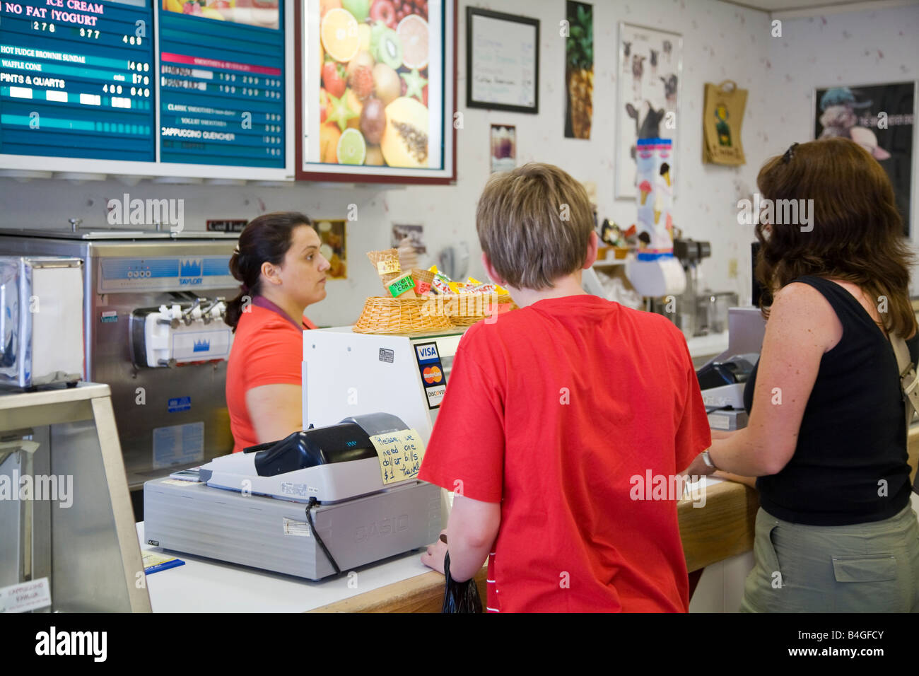 Customers in frozen yoghurt icecream store Stock Photo Alamy