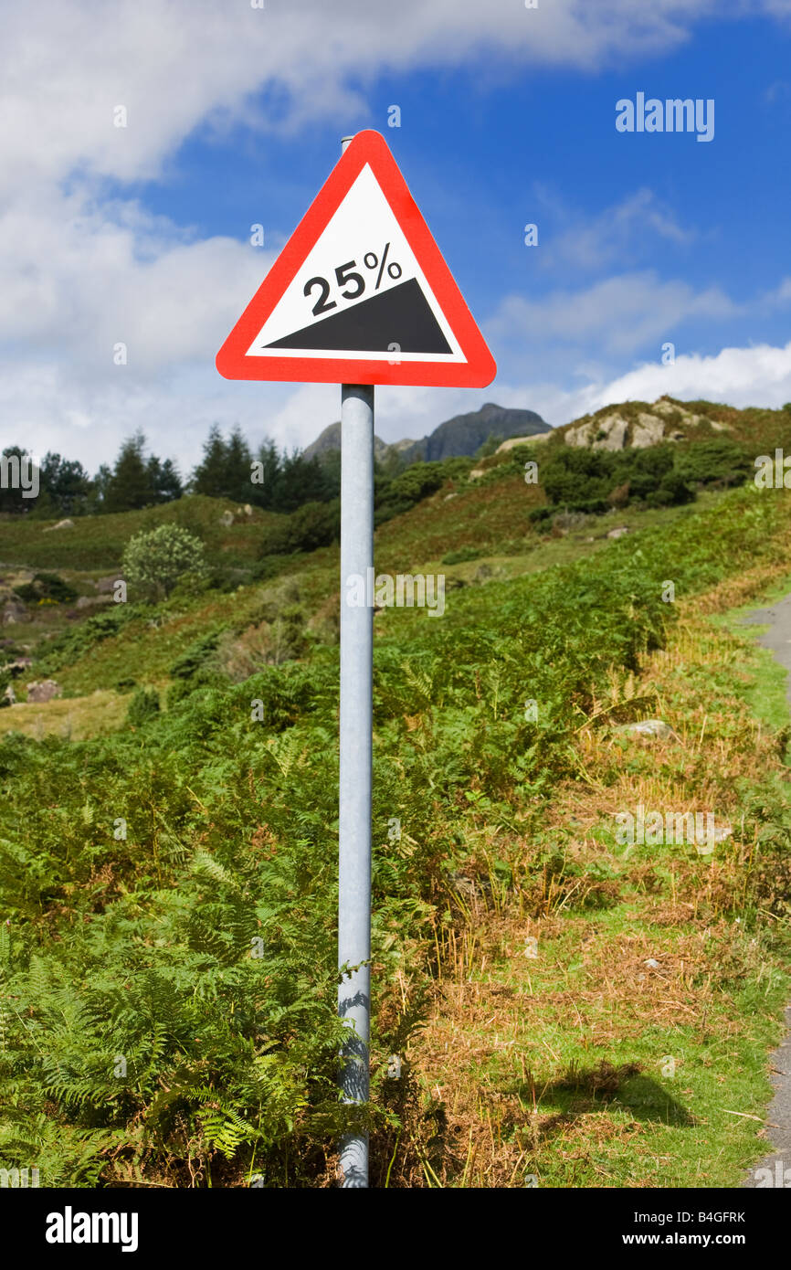 Road sign in countryside with warning of 25 percent gradient ahead England UK Stock Photo