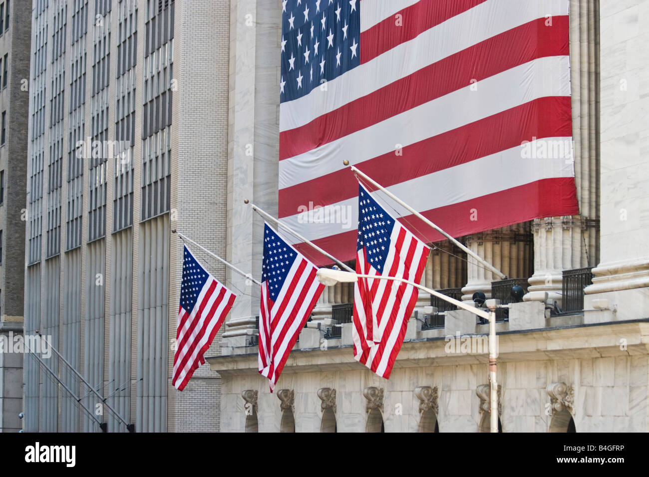 US flags are seen at the New York Stock Exchange. Stock Photo
