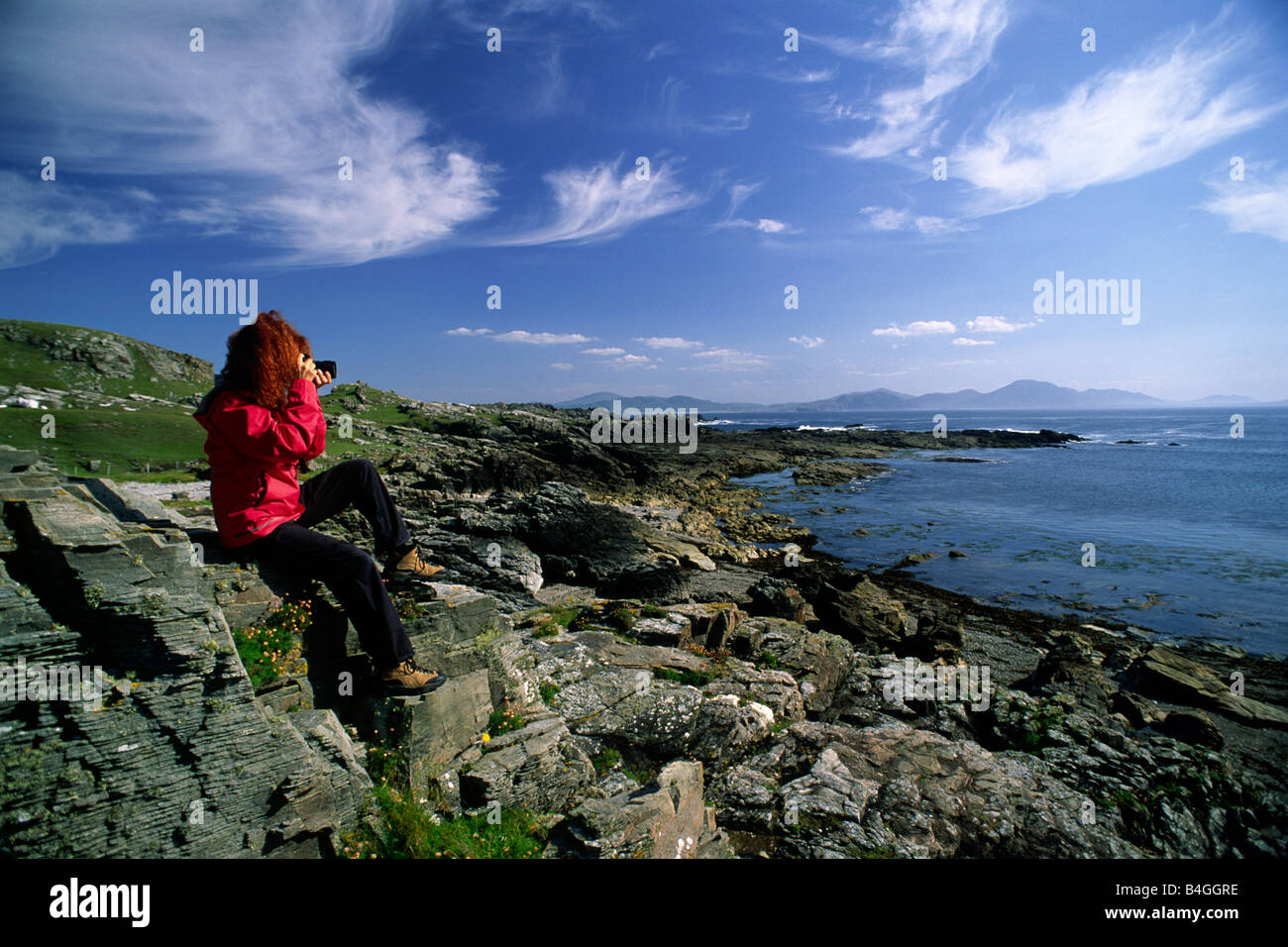 Ireland, County Donegal, Malin Head, the most northerly point in Ireland, girl taking pictures Stock Photo