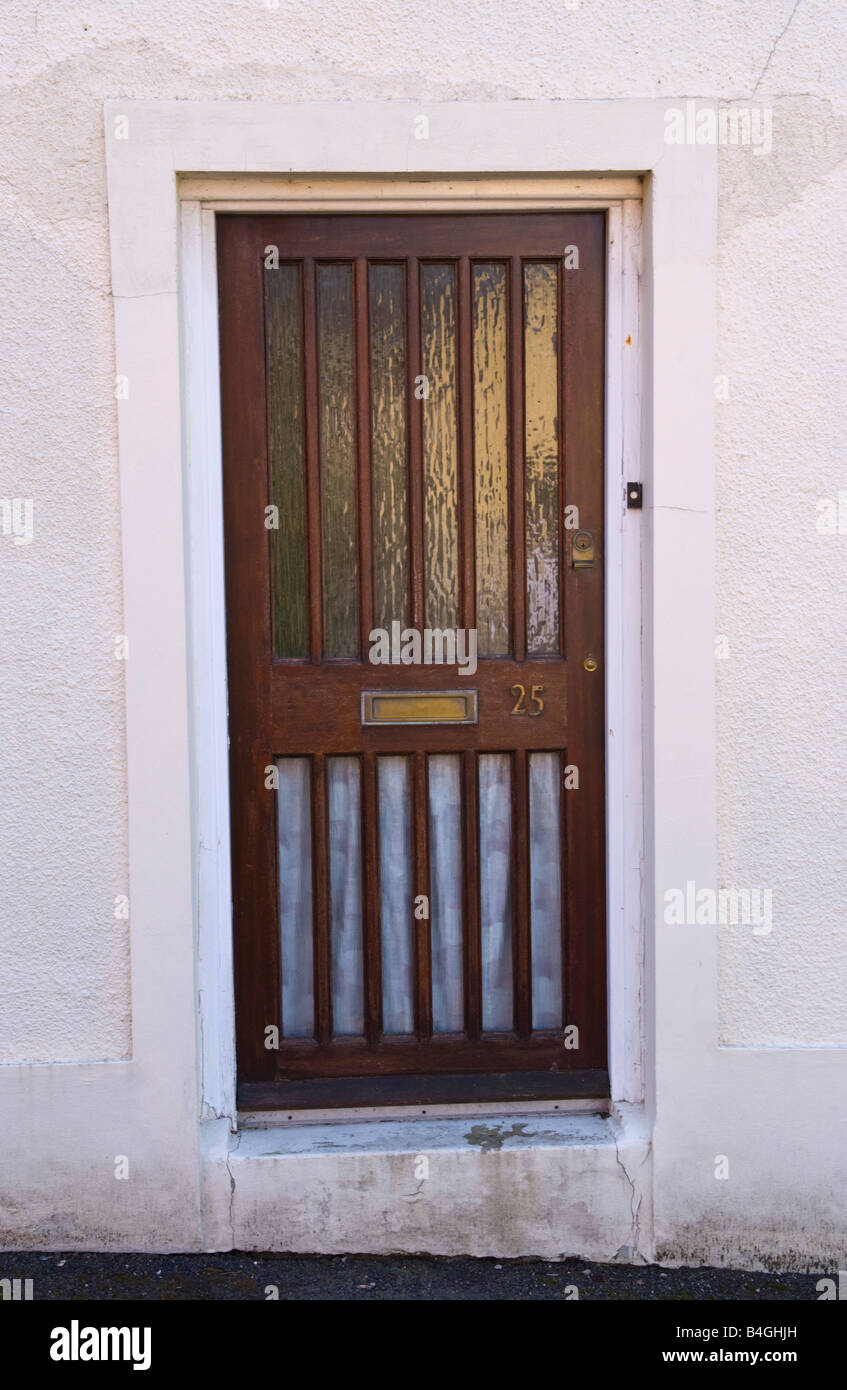Modern glazed front door with brown woodwork of house UK Stock Photo