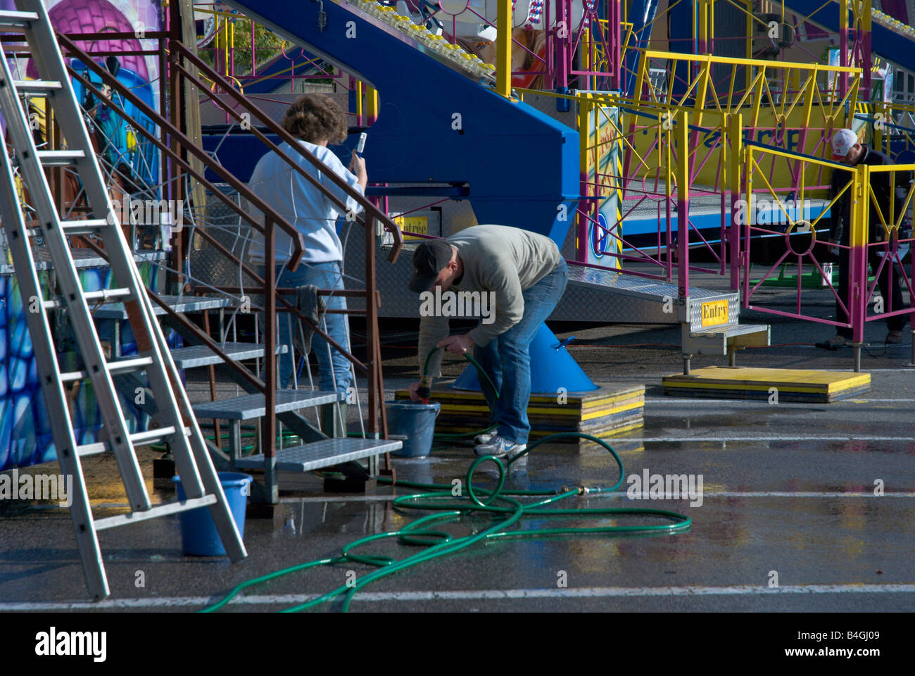 Carnival workers wash a carnival ride at the Fete des Vendanges; Neuchatel, Switzerland Stock Photo