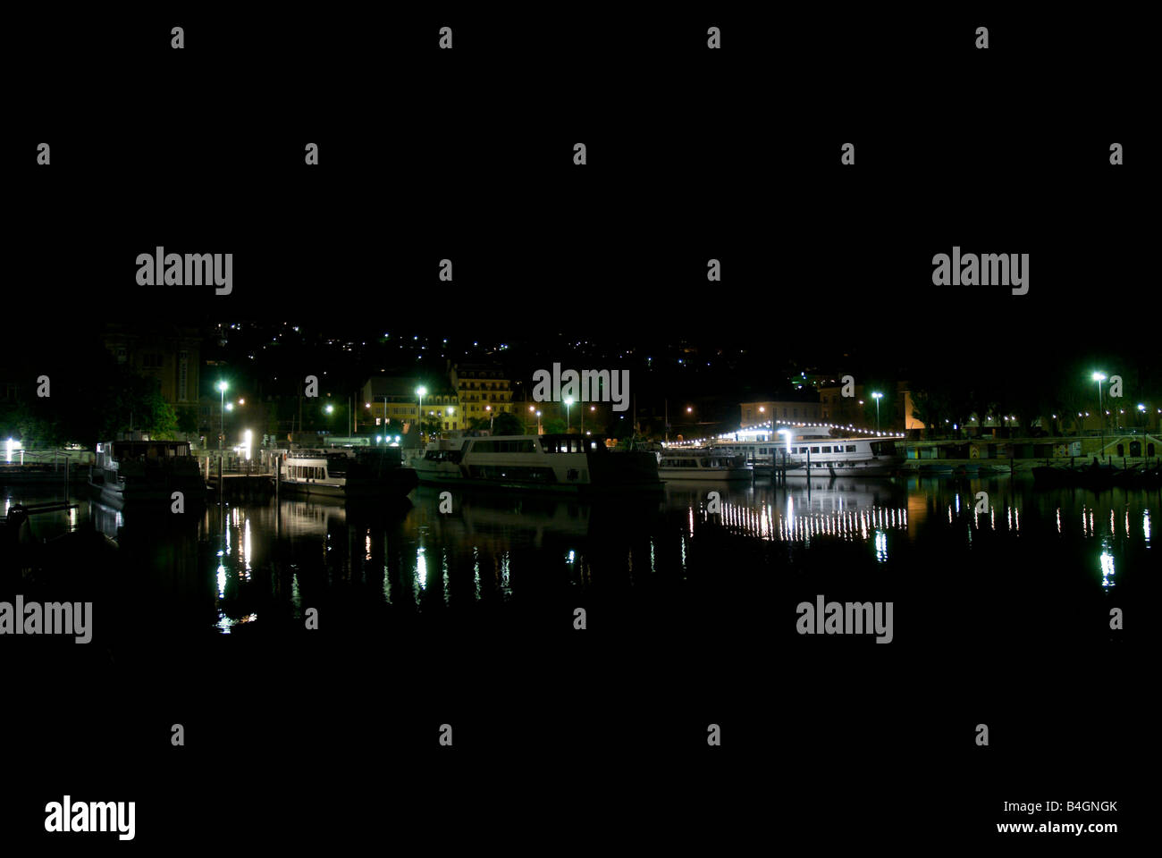 Harbor lights reflecting off the lake in the early hours of the morning Stock Photo