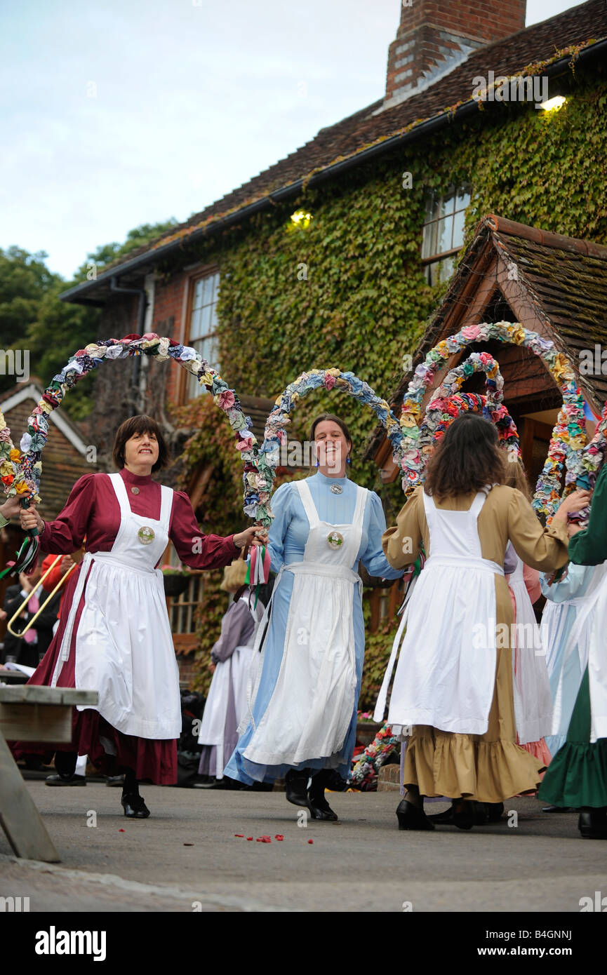 A typical village scene as the knots of May (ladies Morris) dance outside the Kings Head pub in East Hoathly, East Sussex, UK. Stock Photo