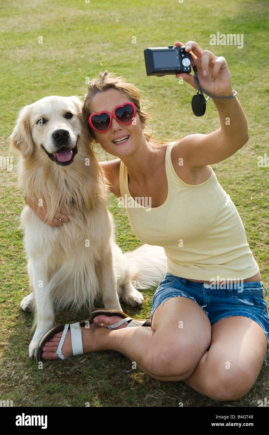 teenage girl taking a photograph of herself and her dog Stock Photo - Alamy