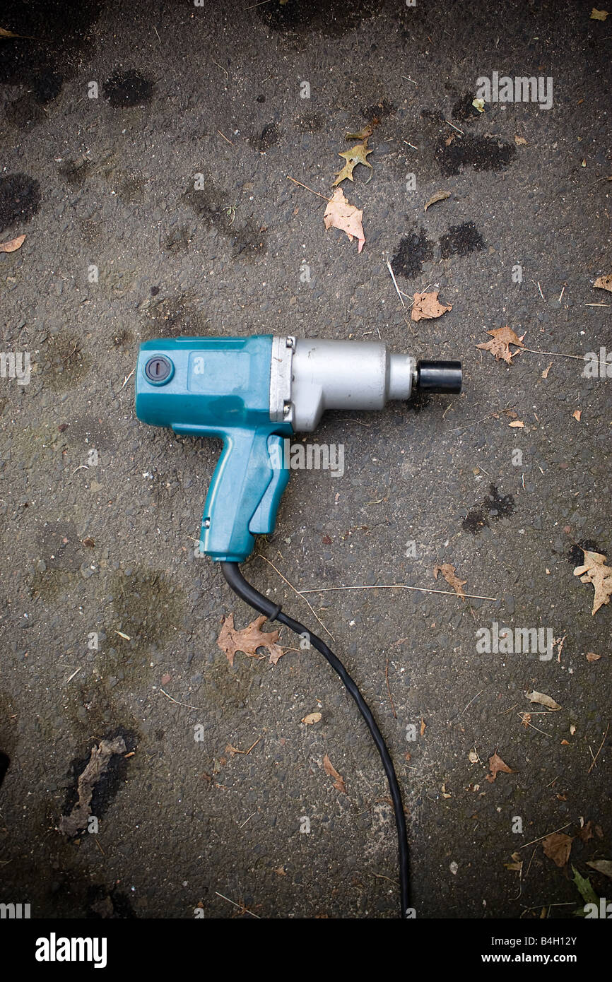 A backyard mechanics impact wrench laying on the blacktop Stock Photo