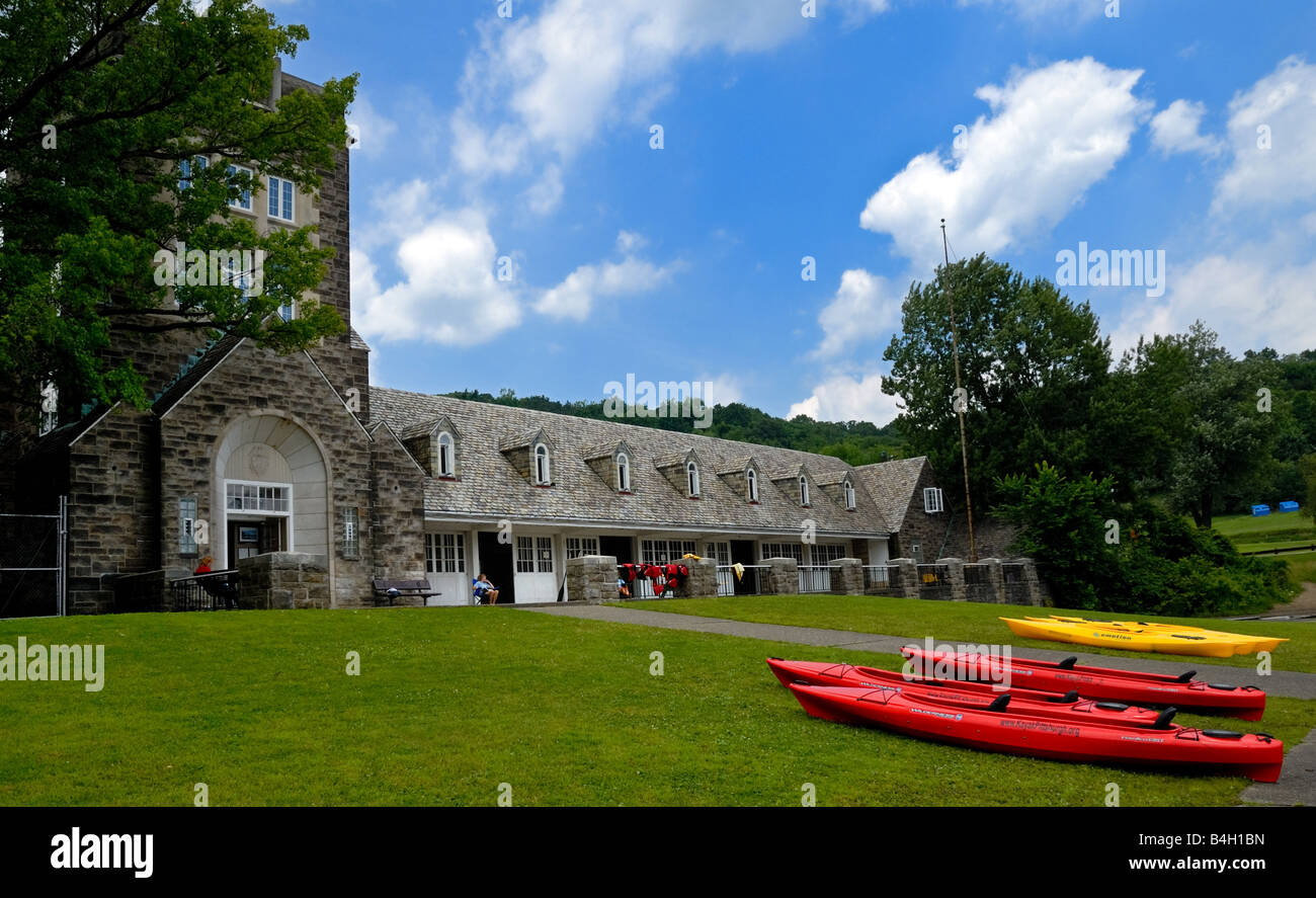 Red and yellow kayaks sit on the shore near the lake at North Park Pittsburgh Pennsylvania Stock Photo