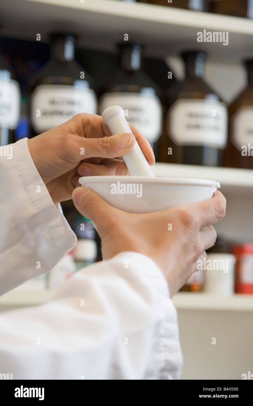 Pharmacist in pharmacy using mortar and pestle Stock Photo Alamy