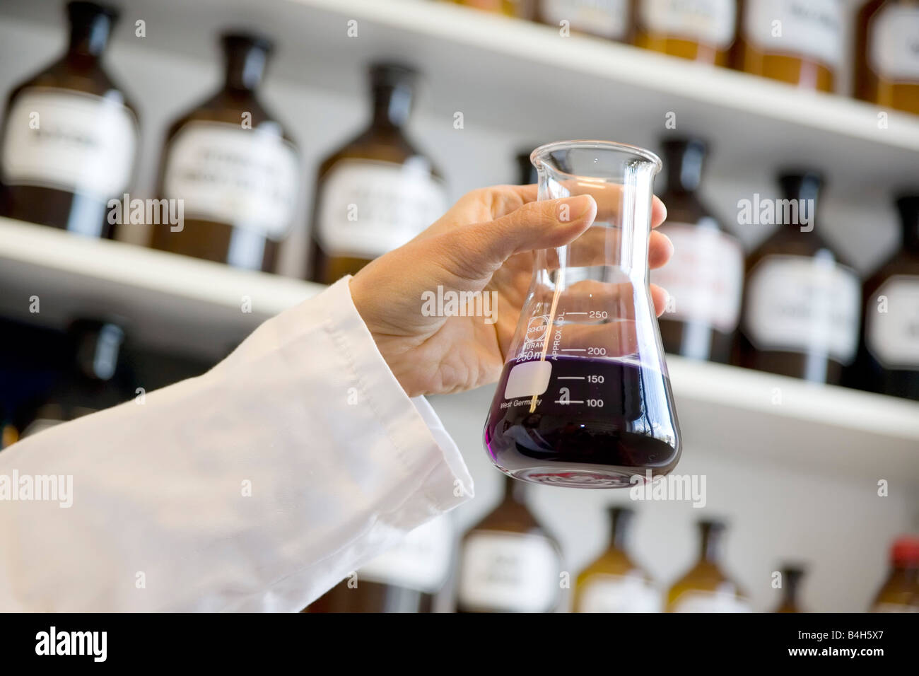 Scientist holding conical flask in laboratory Stock Photo