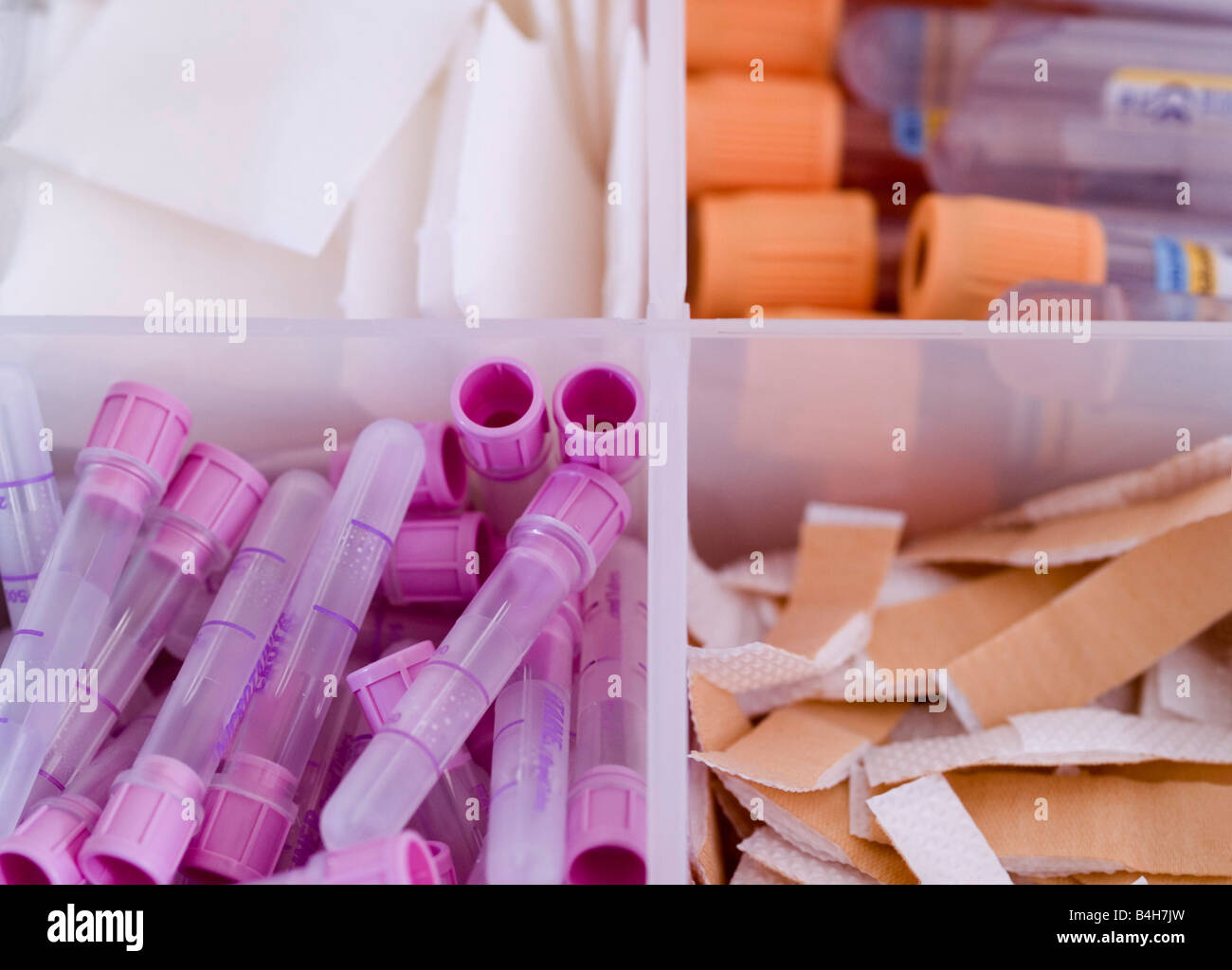 Closeup of adhesive bandages and test tubes in container Stock Photo
