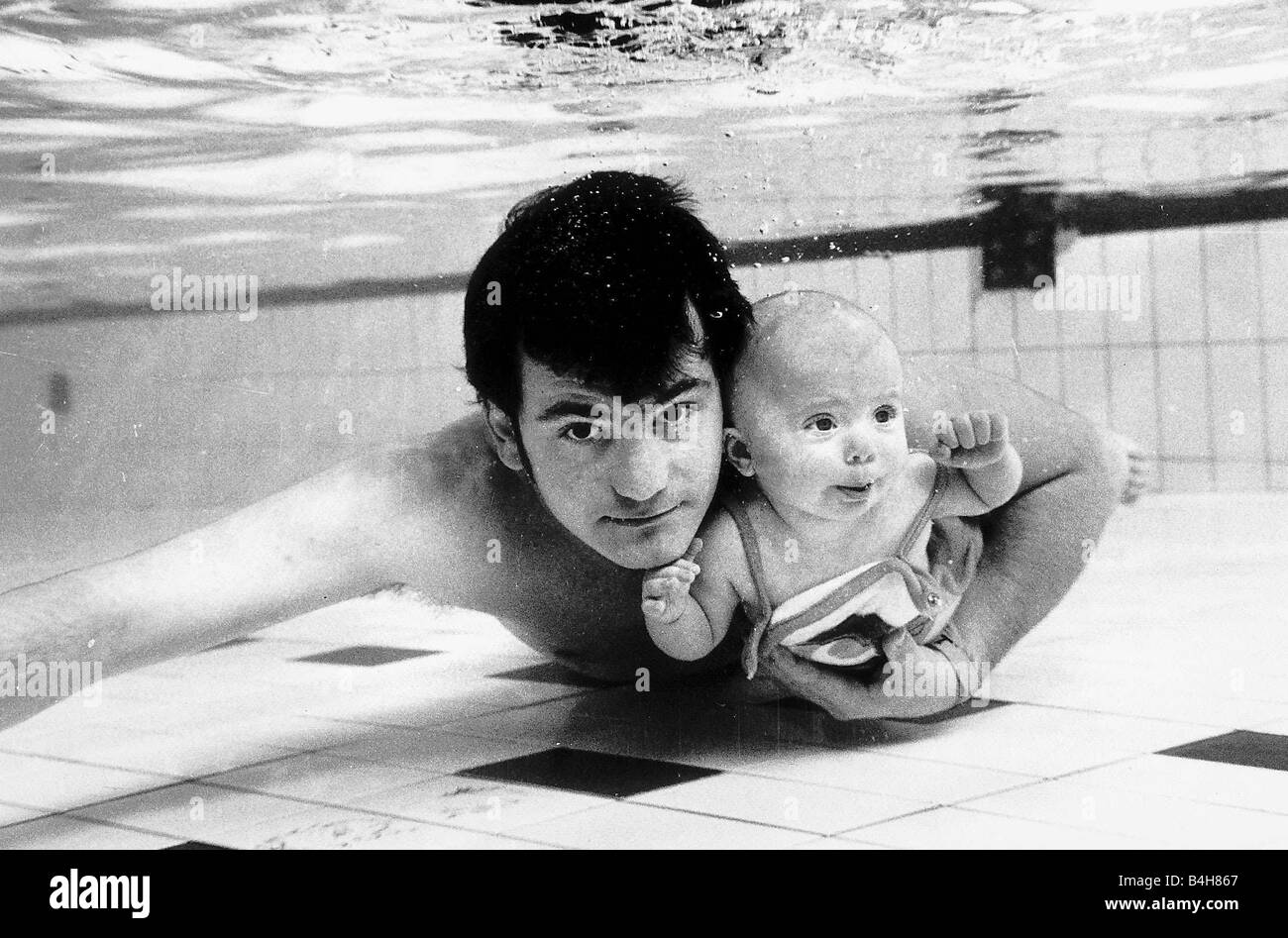 Swimming Underwater baby Tracey four months old with father Steve