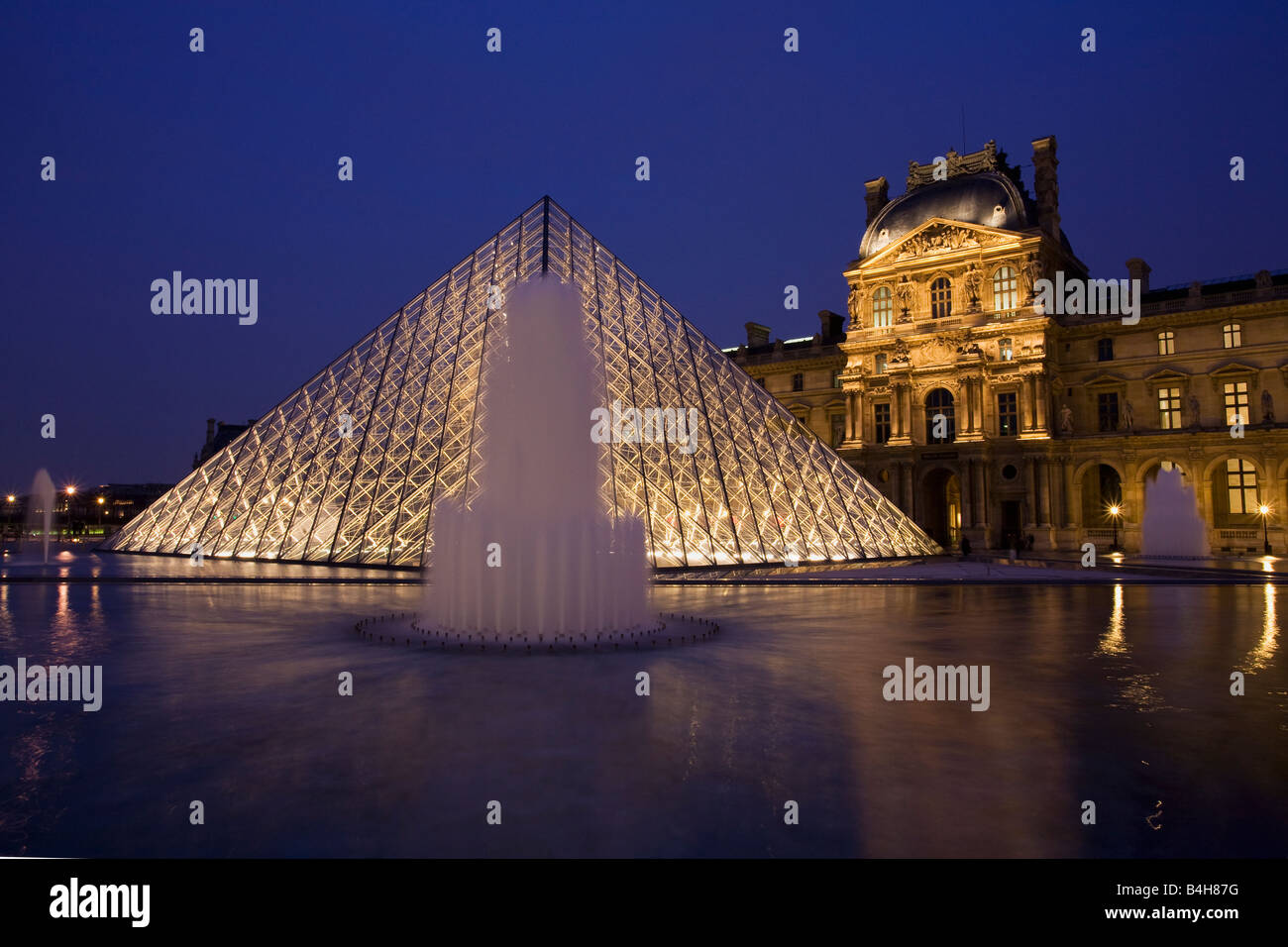 Glass Pyramide at entrance to Le Louvre Museum and Art Gallery at night Paris France Europe EU Stock Photo