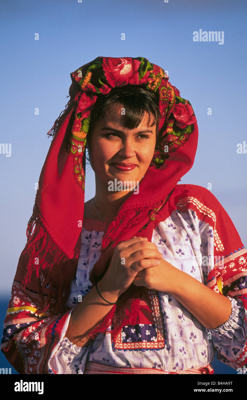 A pretty young Russian girl dressed in traditional peasant clothing on