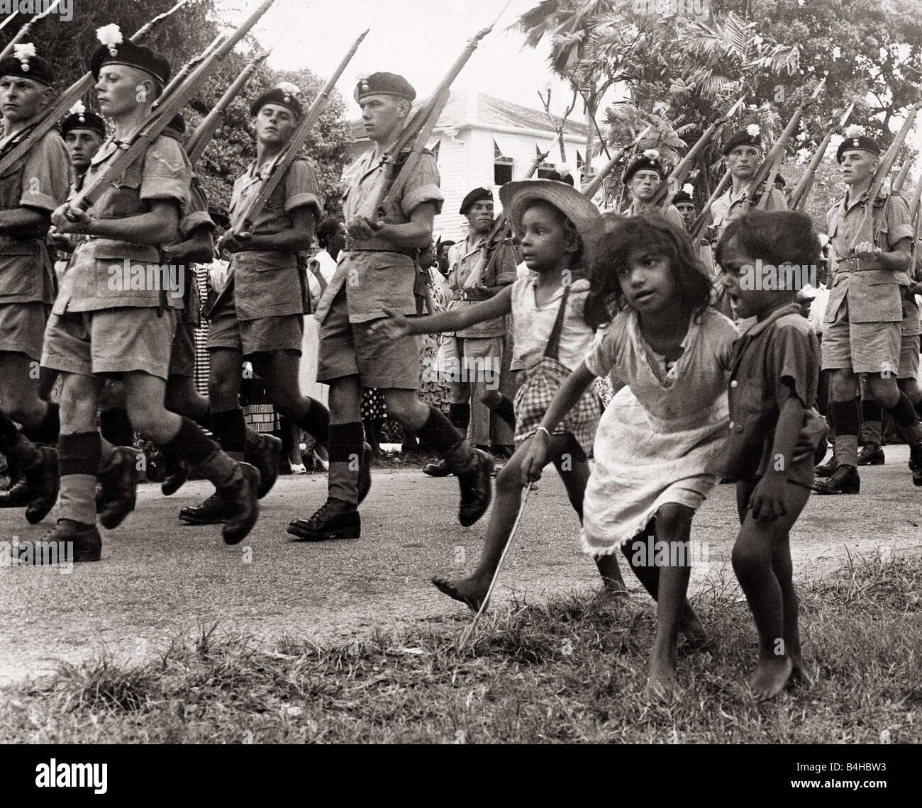 British soldiers marching in Georgetown British Guiana followed by some children in 1953 1953 The Waddington Constitution is suspended on December 22nd The Royal Welsh Fusiliers are despatched to Guyana to control any outbreak of violence which may follow the suspension The House of Assembly is disbanded All Stock Photo