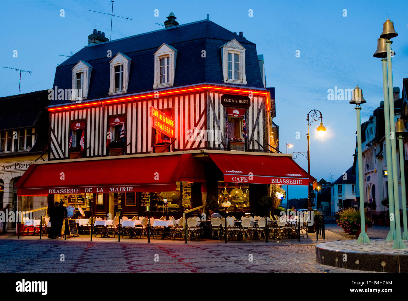 Coffee shop lit up at dusk, Deauville, Cote Fleurie, Basse-Normandy, Normandy, France Stock Photo