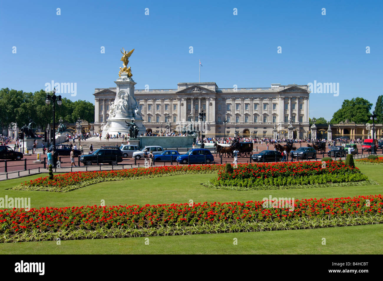 Flowers blooming in garden with palace in background Buckingham Palace City Of Westminster London England Stock Photo
