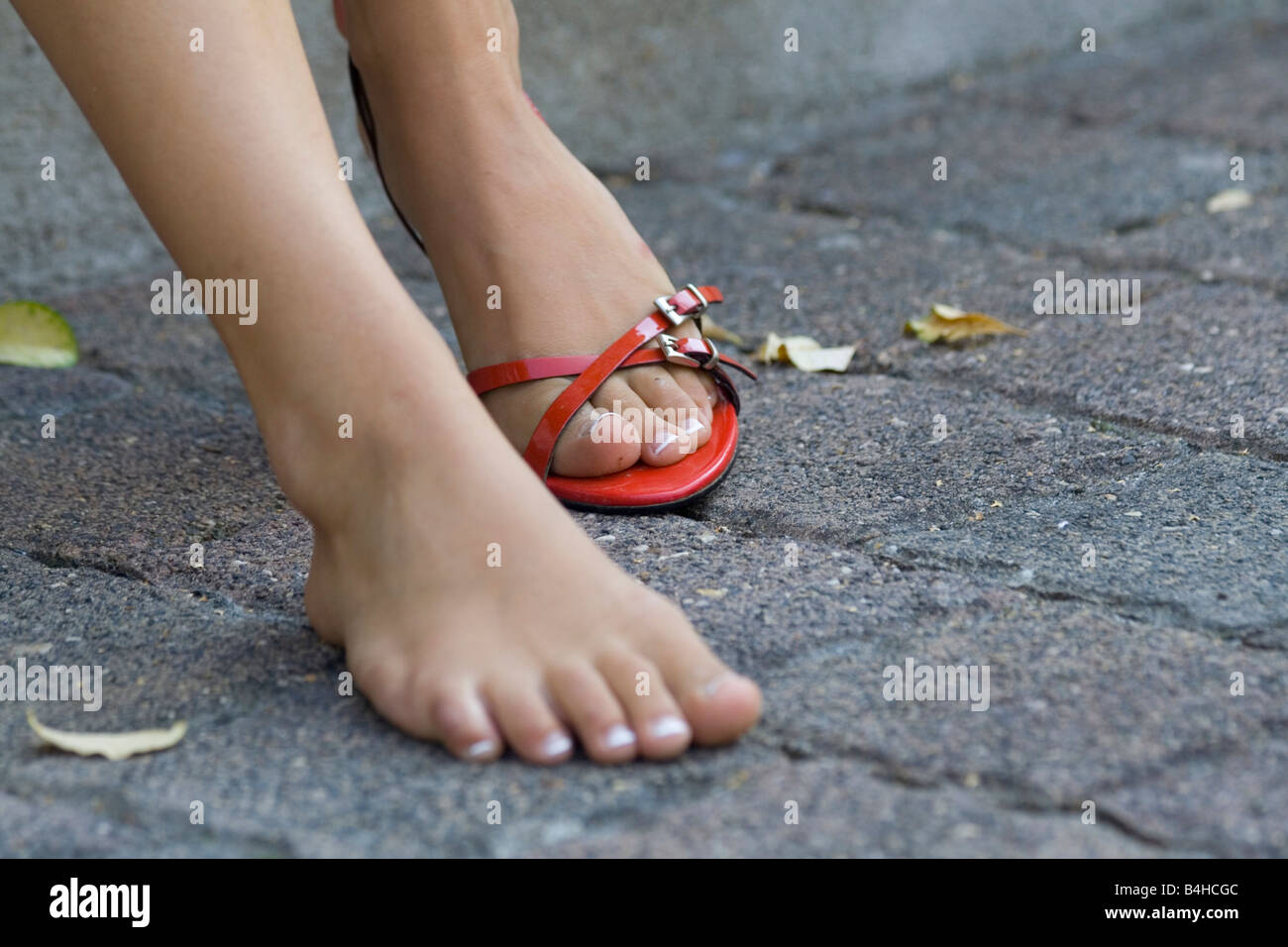 Low section view of woman taking of her sandal Stock Photo
