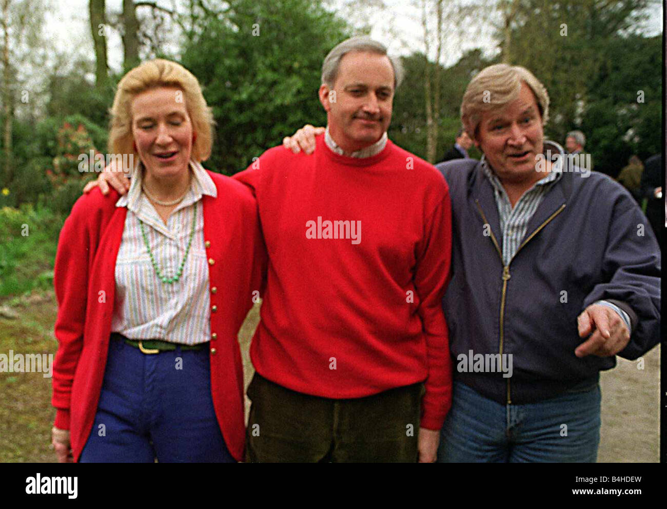 Neil Hamilton the Conservative MP at the centre of a cash for questions scandal poses for photographers outside his Cheshire home with his wife Christine and television star Bill Roache who plays Ken Barlow in Coronation Street Roache a family friend told journalists of his support for Hamilton who is coming under increasing presure to step down from the forthcoming general election in the light of the allegations made against him Stock Photo