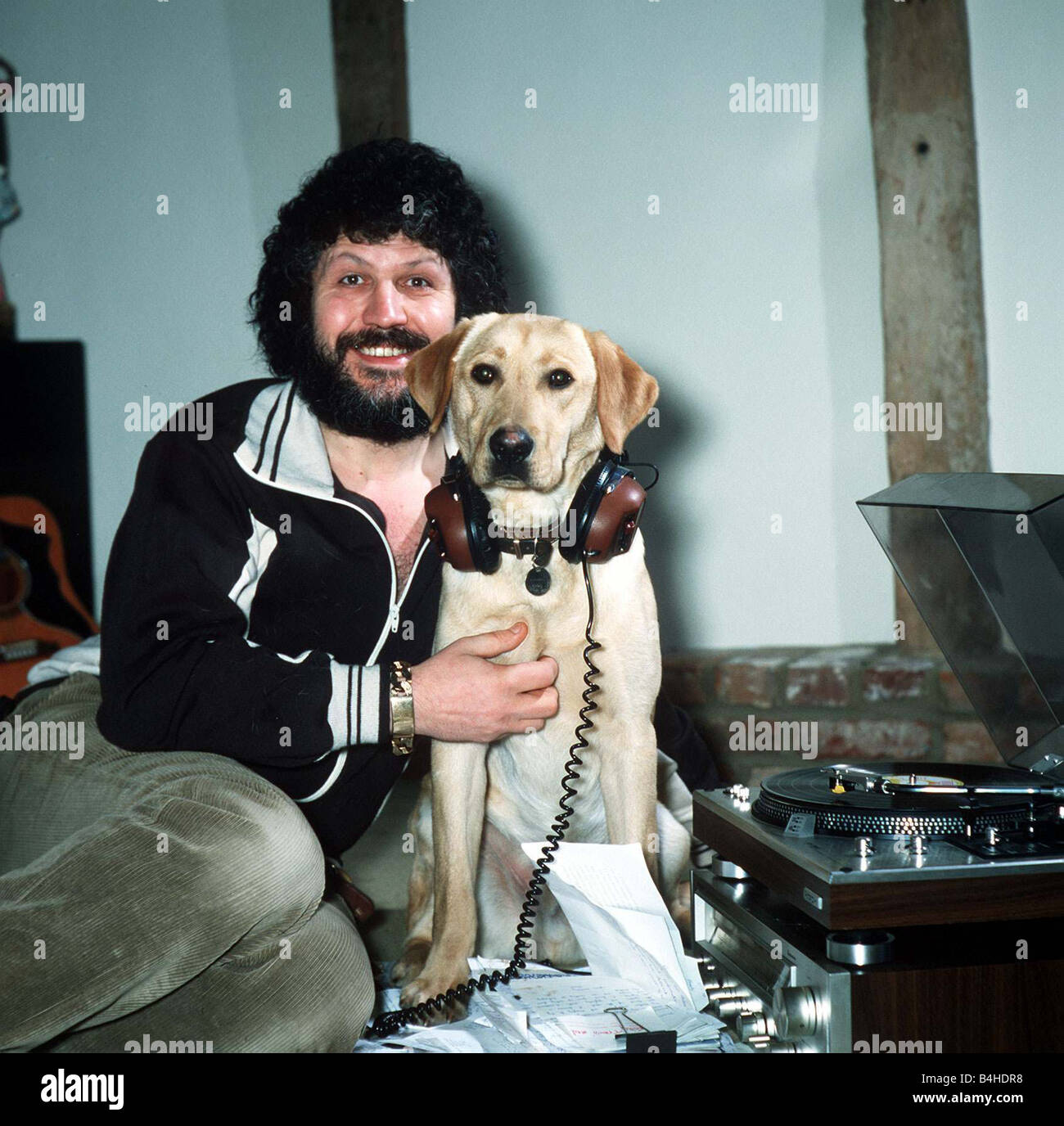 DJ Dave Lee Travis at home with his dog March 1981 Stock Photo
