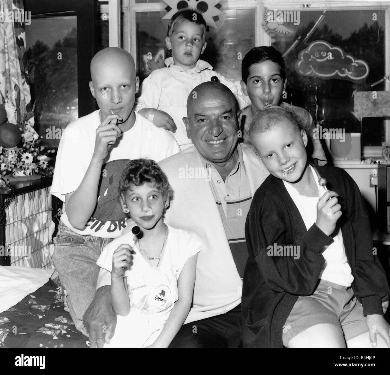 Telly Savalas actor with young cancer patients in June 1989 at the Royal Marsden Hospital in Surrey Stock Photo