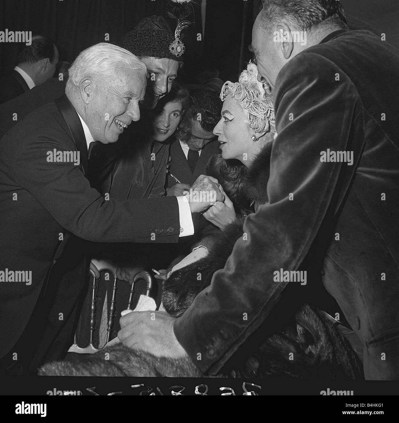 Charlie Chaplin talking with Madame Grund wife of French publisher at the Ice Ball in Paris France December 1954 Stock Photo