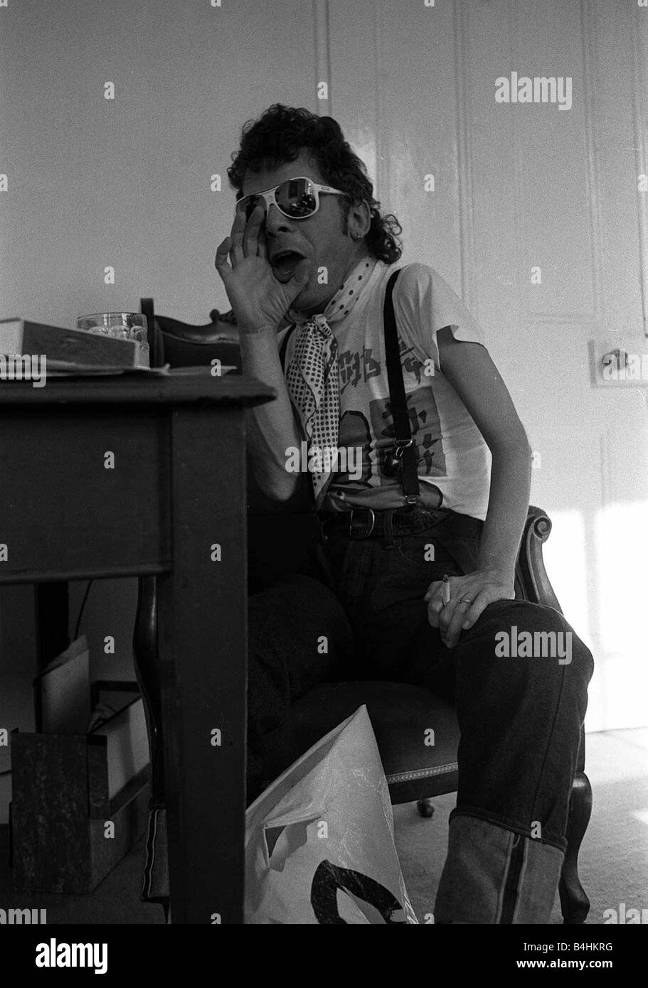 Rock Star Ian Dury poses during an exclusive interview for the Daily Mirror in his offices in Paddington London 1981 Stock Photo