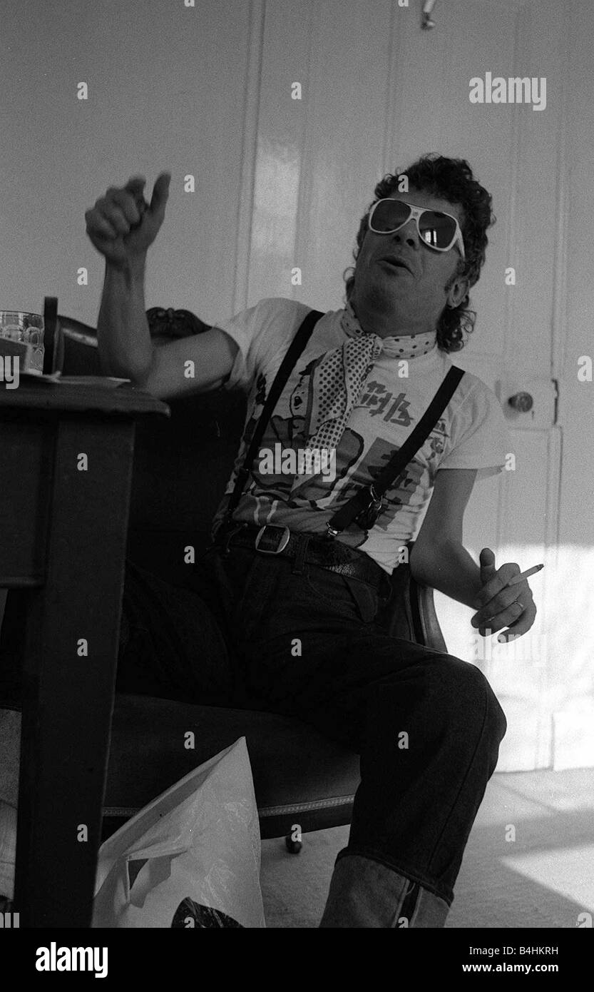 Rock Star Ian Dury poses during an exclusive interview for the Daily Mirror in his offices in Paddington London 1981 Stock Photo
