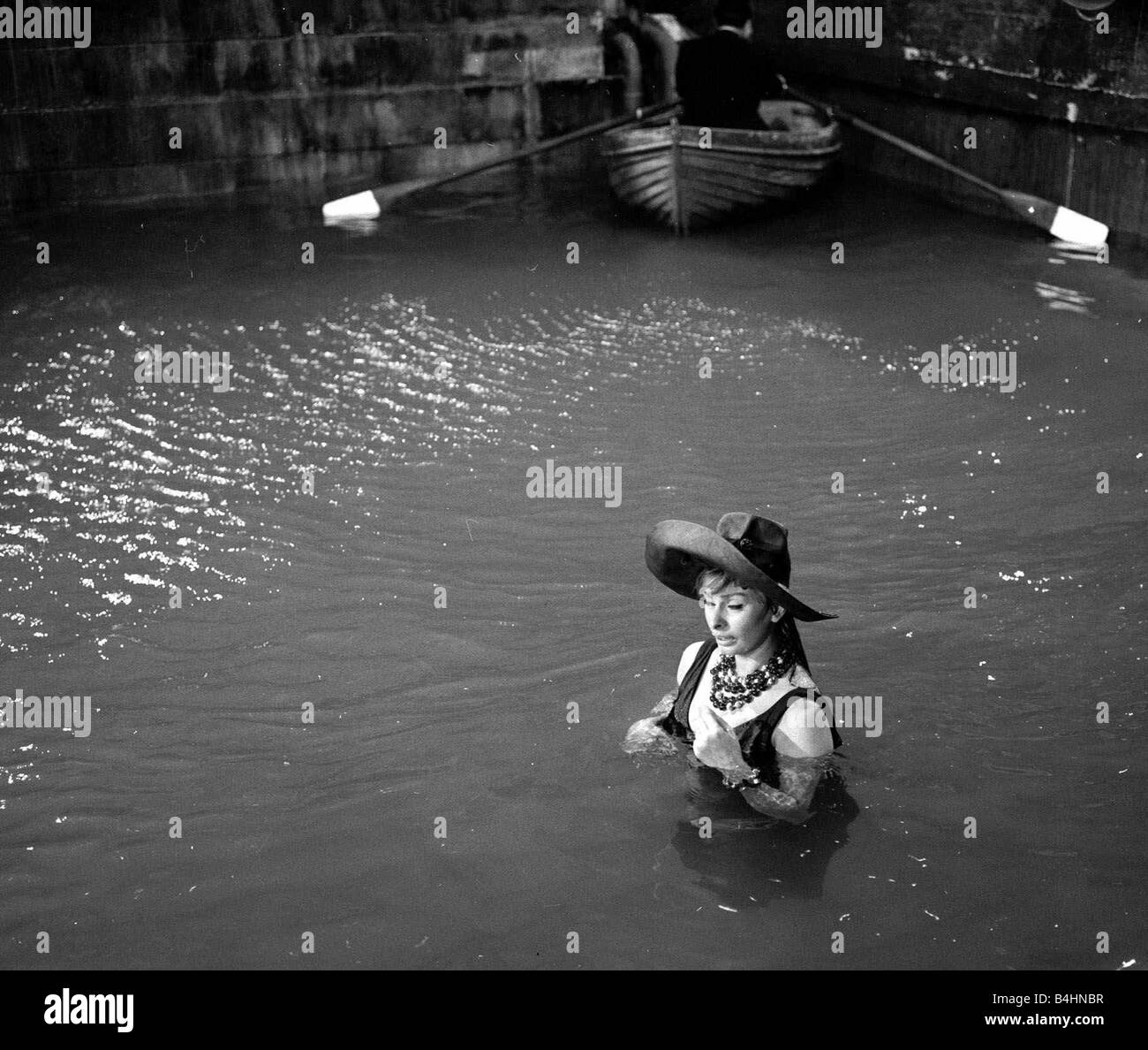 The making of The Millionairess Film July 1960 Pictured Sophia Loren Italian Actress in water during filming Plot Summary When her father dies Epifania Parerga an Italian in London becomes the world s richest woman She feels incomplete without a husband and falls in love with a humble Indian physician Dr Ahmed el Kabir Peter Sellers Stock Photo