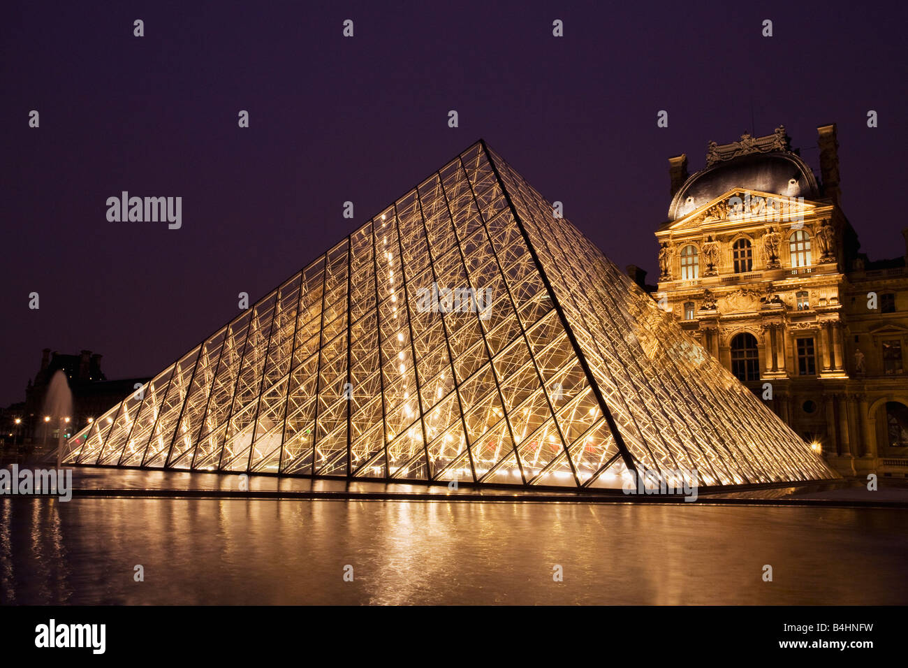 Glass Pyramide at entrance to Le Louvre Museum and Art Gallery at night Paris France Europe EU Stock Photo