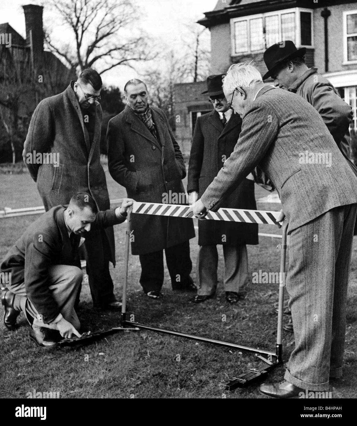 Olympic Games 1948 Mr Rottenburg explains the action of the extension feet of his metal hurdle Stock Photo