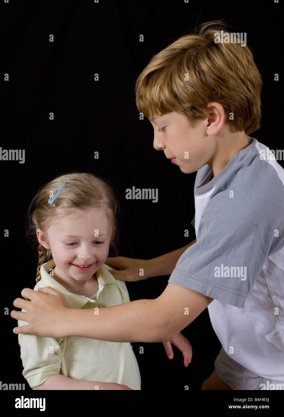 color portrait, two children, girl, boy, holding, looking. connection