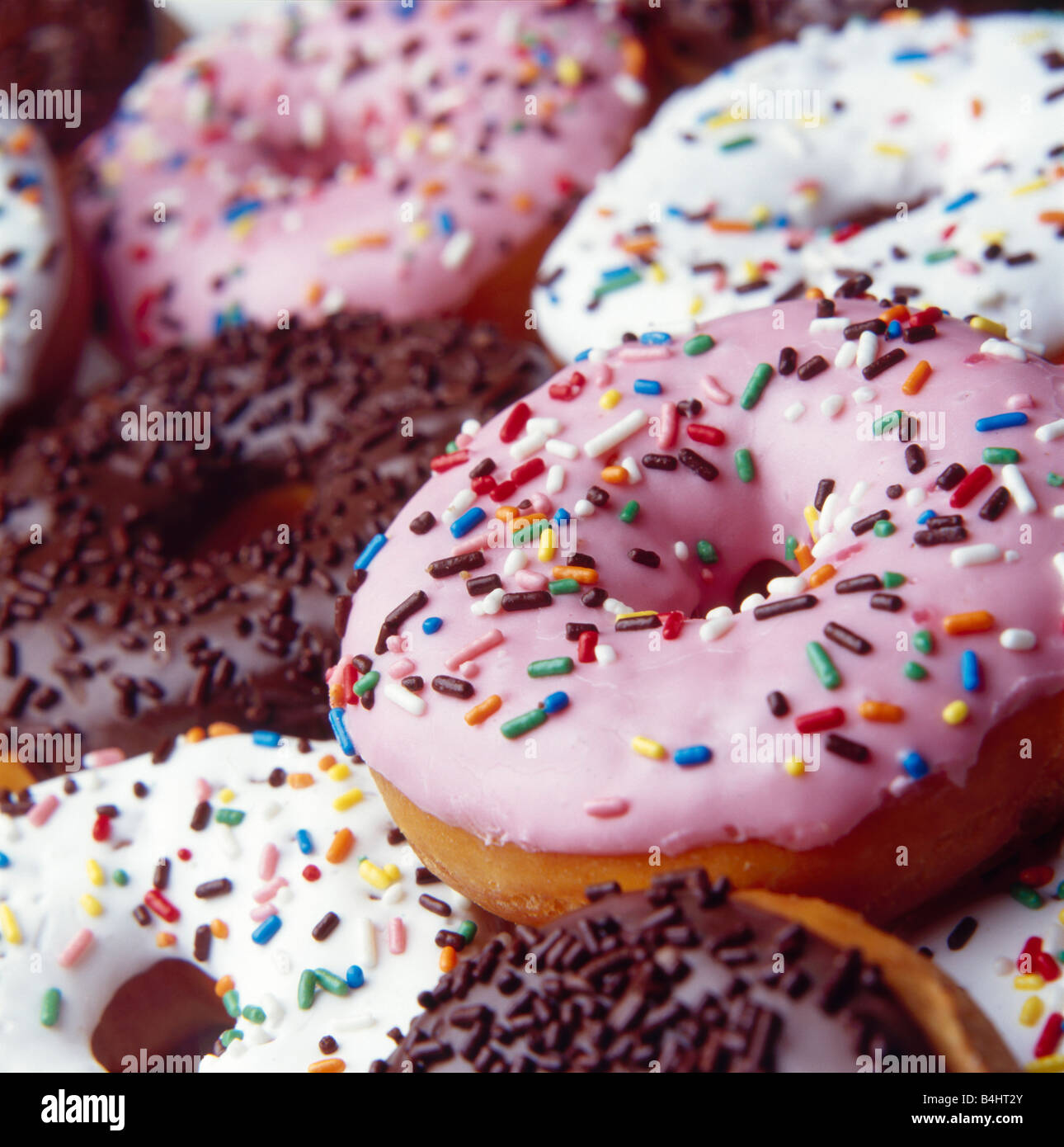 Pile of iced ring doughnuts with sprinkles Stock Photo Alamy