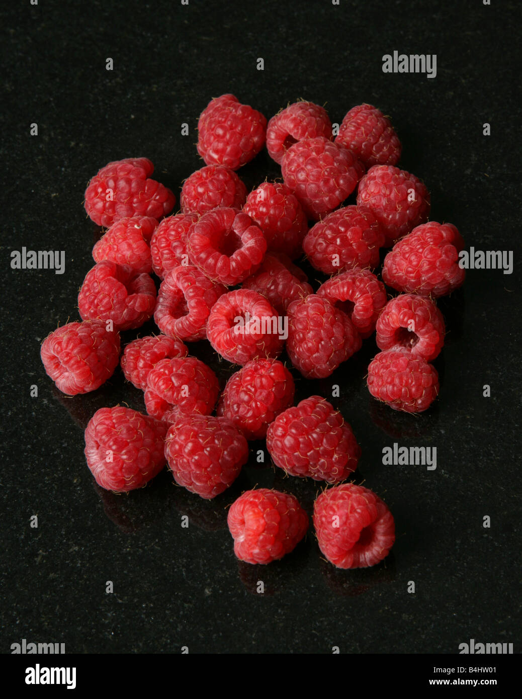 Raspberries on black granite Stock Photo