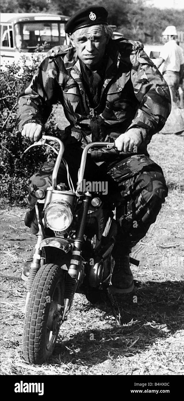 Richard Harris Irish actor on set of film Wild Geese 1977 riding motorcycle in army uniform Stock Photo