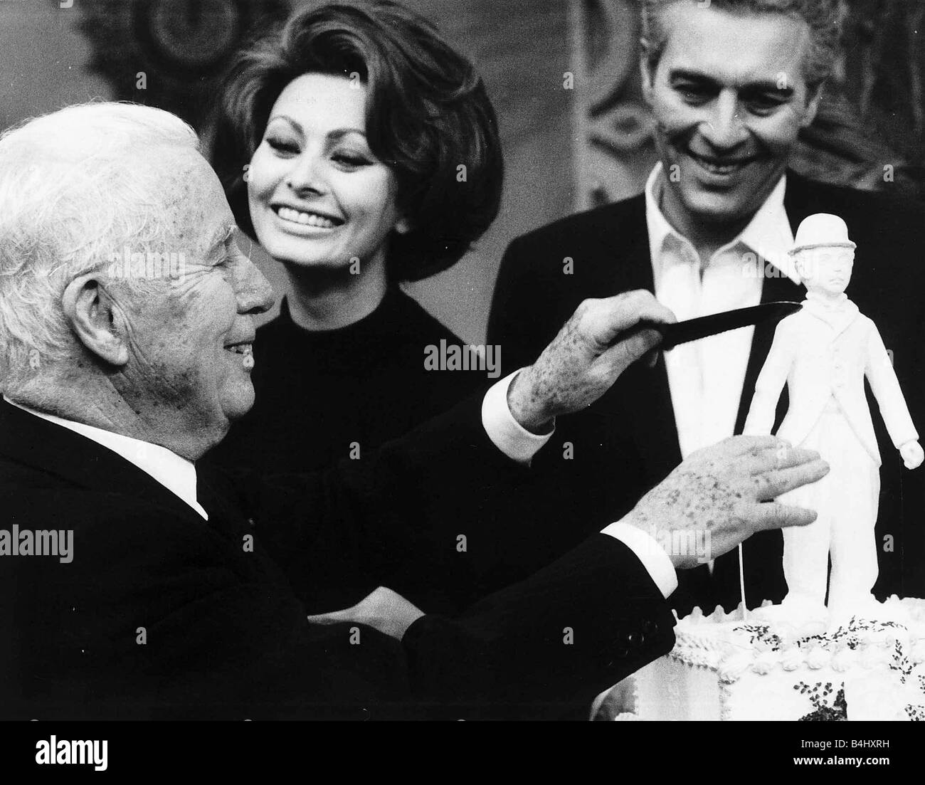 Charlie Chaplin Actor Celebrating his 77 birthday cutting a cake with Sophia Loren Actress and Son Sydney Stock Photo
