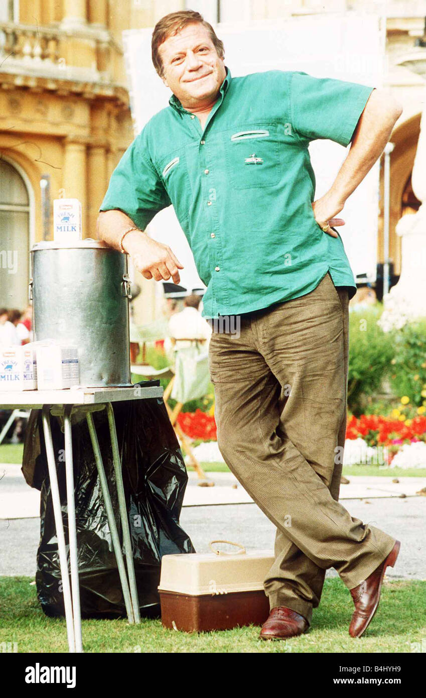 Oliver Reed hands clasped wearing costume as he appears in film