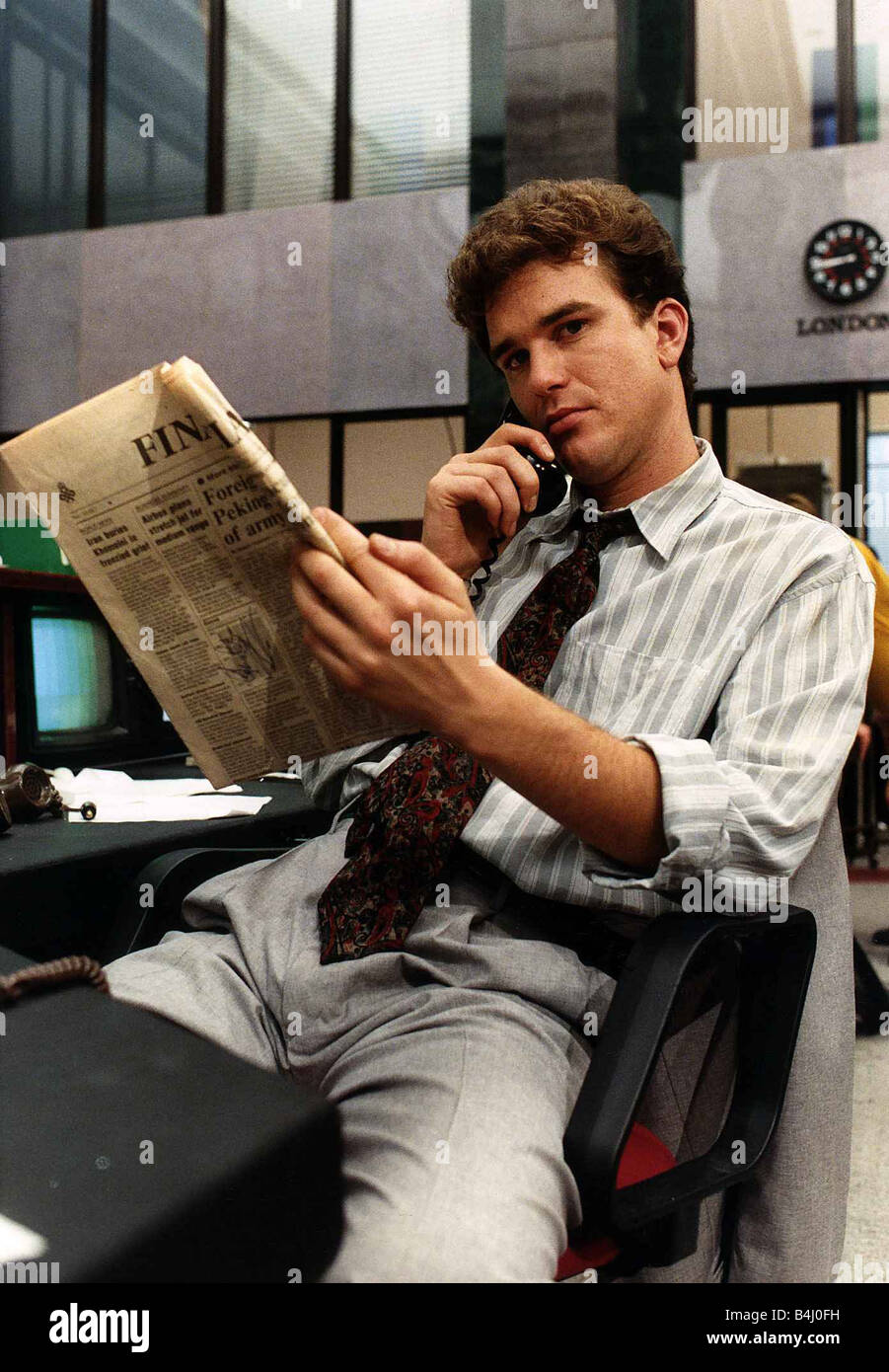 Douglas Hodge actor from TV programme Capitol City sitting on desk