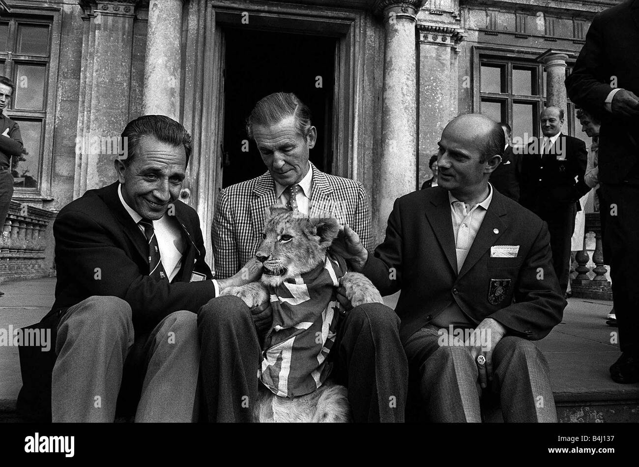 World Cup England 1966 Gottfried Dienst LEFT Swiss World Cup Final Referee with Lord Bath CENTRE and Rudolf Kreitlein German Referee RIGHT at Longleat to visit Lord Baths Lion Cubs Lion Cub wearing Union Jack Stock Photo
