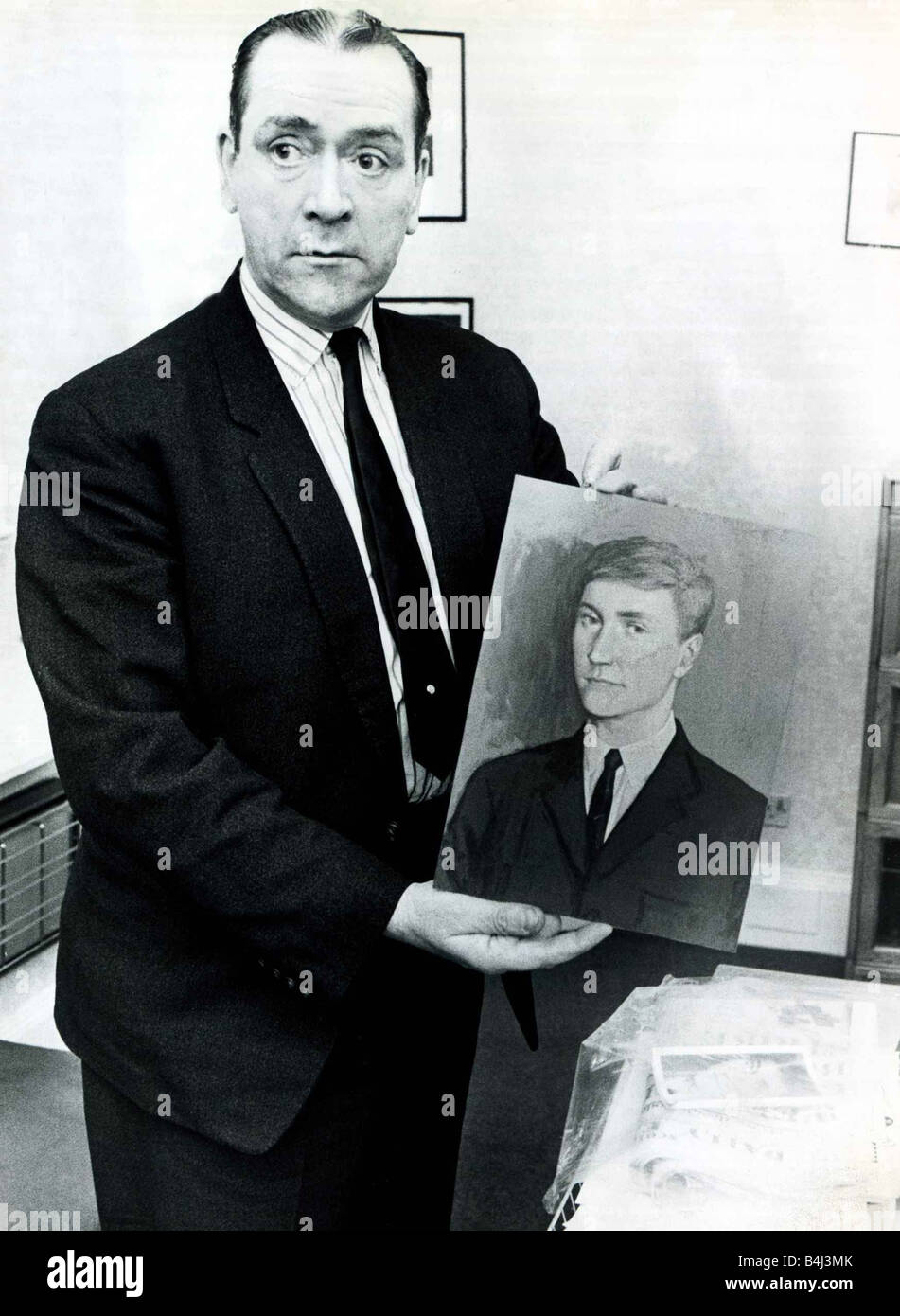 Crime Murder Superintendent Joe Beattie who conducted a search for the killer nicknamed Bible John of whom he holds a portrait November 1969 Stock Photo