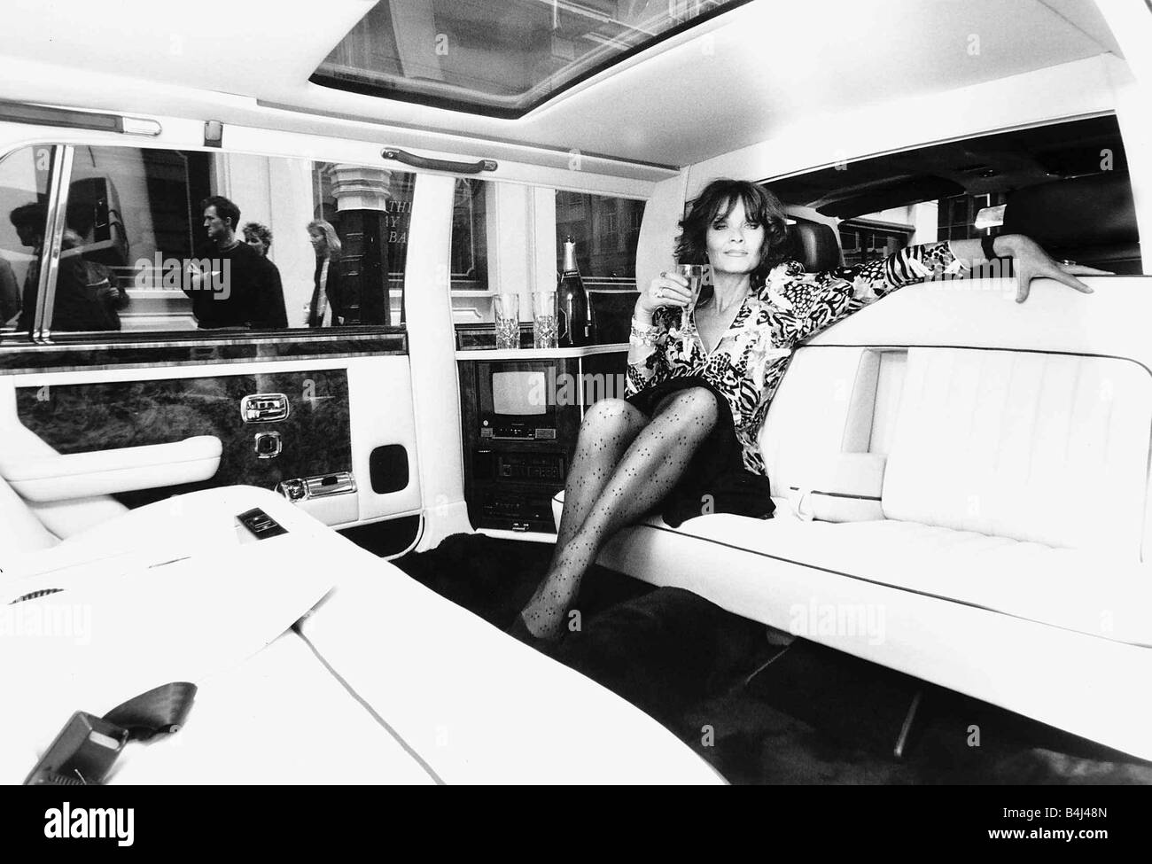 Kate O Mara relaxes With a glass of Champagne in the back of a Rolls Royce October 1987 Dbase MSI Stock Photo