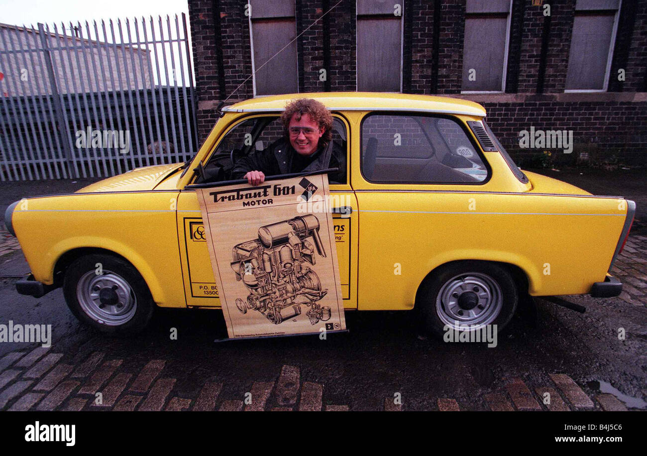 Trabant motor car East German December 1997 Road Record yellow owner unknown holding poster Stock Photo