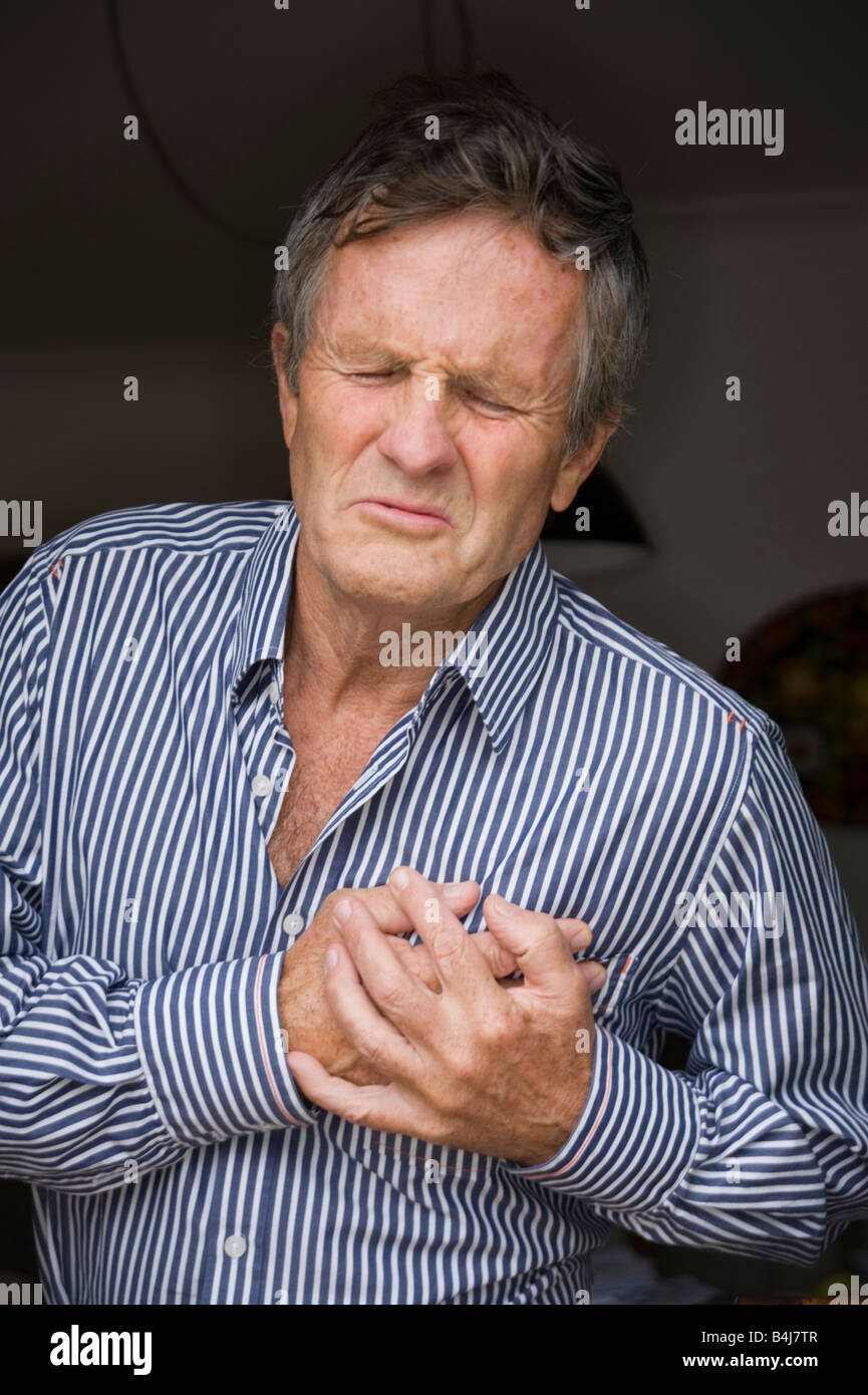 middle aged man clutching his heart Stock Photo Alamy