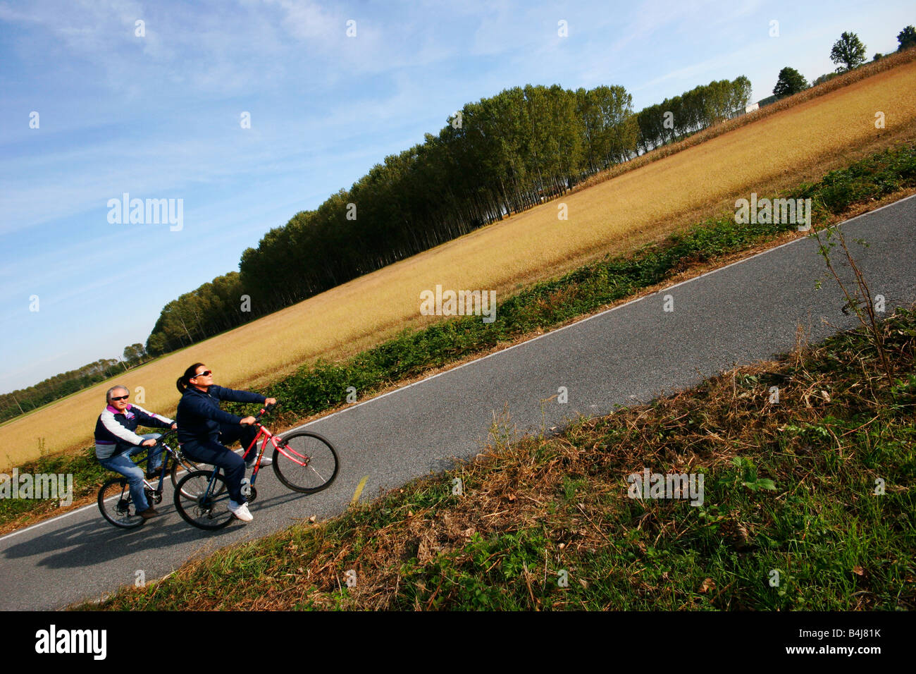 Retired couple riding bikes in the countryside. Stock Photo