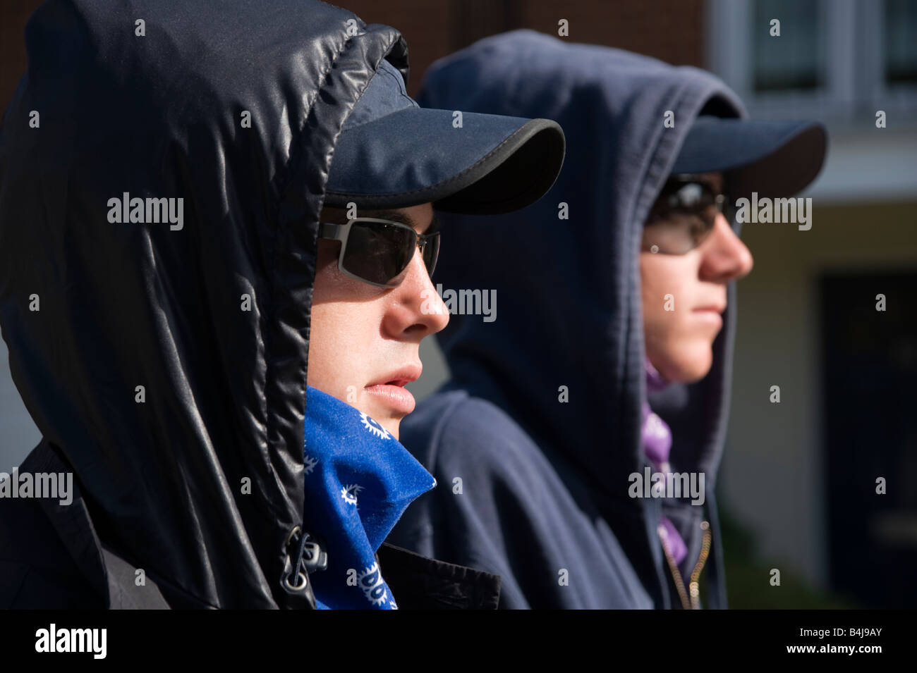 2 teenage boys in hoodies and dark glasses Stock Photo
