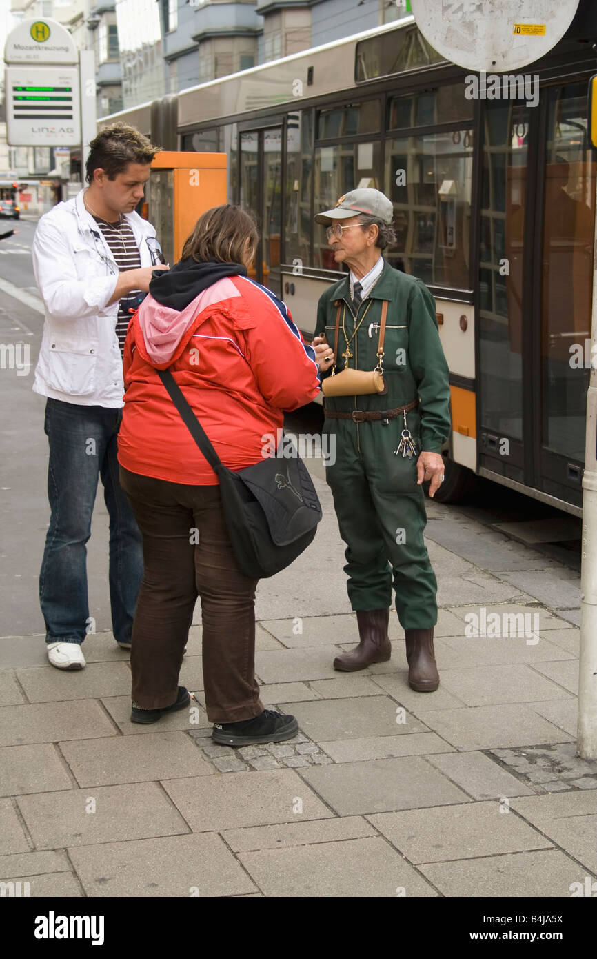 Inspector checking tickets in the street in Linz, Austria Stock Photo
